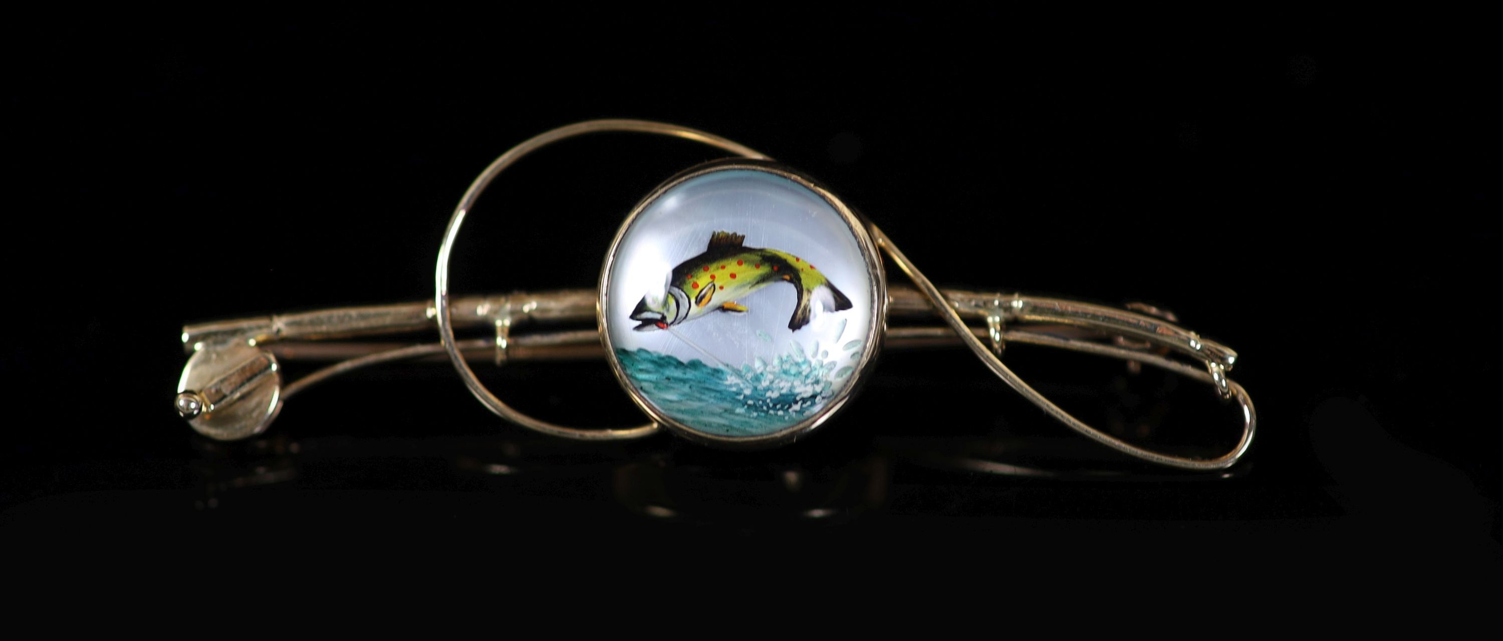 An Edwardian 18ct gold and Essex crystal set bar brooch, modelled as a fly fishing rod, with line and reel